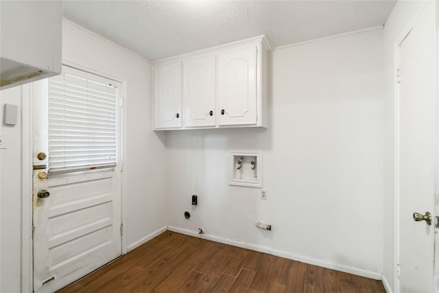 washroom featuring crown molding, cabinet space, wood finished floors, and hookup for a washing machine