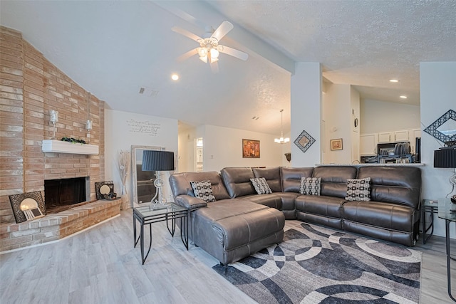 19944 Mountain Dale Dr, Cypress, TX 77433 - living area with lofted ceiling, a ceiling fan, wood finished floors, a textured ceiling, and a fireplace