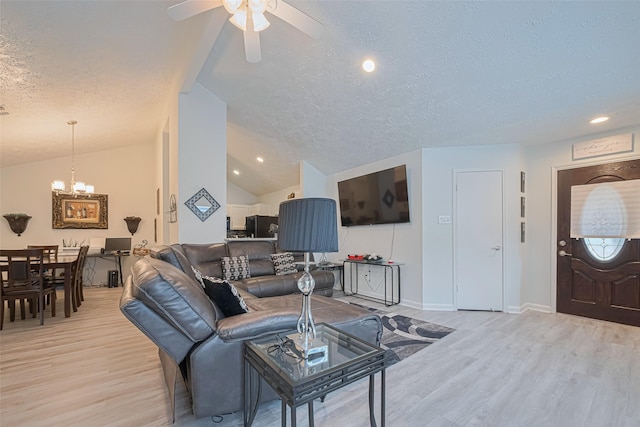 19944 Mountain Dale Dr, Cypress, TX 77433 - living room with light wood finished floors, a textured ceiling, lofted ceiling, a ceiling fan, and a chandelier