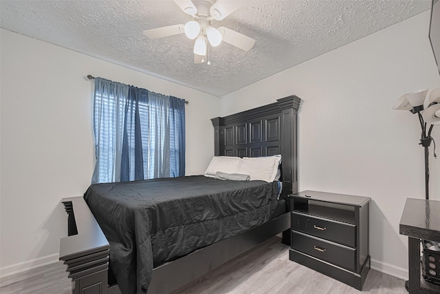 19944 Mountain Dale Dr, Cypress, TX 77433 - bedroom featuring a textured ceiling, light wood-style flooring, baseboards, and a ceiling fan