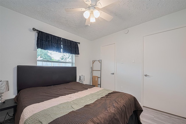19944 Mountain Dale Dr, Cypress, TX 77433 - bedroom with a textured ceiling, wood finished floors, and ceiling fan