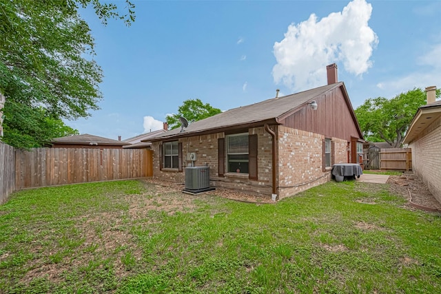 19944 Mountain Dale Dr, Cypress, TX 77433 - back of house featuring brick siding, a chimney, and cooling unit