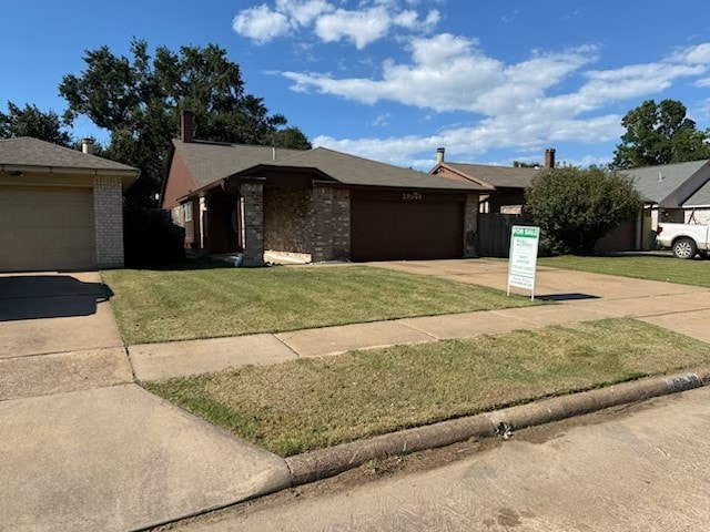 19944 Mountain Dale Dr, Cypress, TX 77433 - view of front facade featuring a front lawn, concrete driveway, a garage, and brick siding