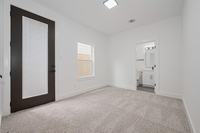 3114 Orange St, Houston, TX 77020 - unfurnished bedroom featuring baseboards, connected bathroom, carpet, and visible vents