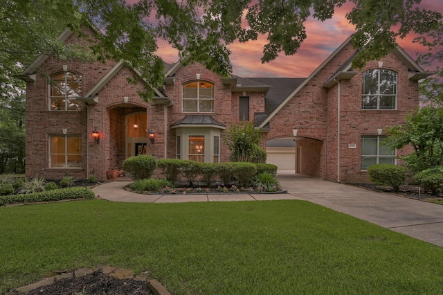 13262 Royal Rdg, Conroe, TX 77302 - traditional home with driveway, a yard, a garage, and brick siding