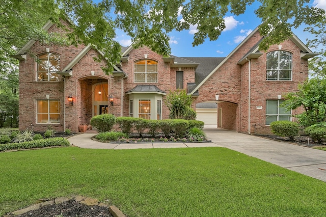 13262 Royal Rdg, Conroe, TX 77302 - traditional home featuring a front lawn, concrete driveway, and brick siding