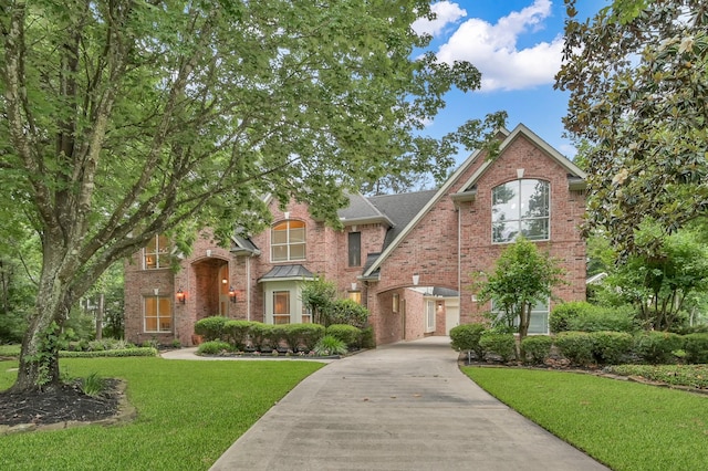 13262 Royal Rdg, Conroe, TX 77302 - traditional home featuring driveway, brick siding, and a front lawn