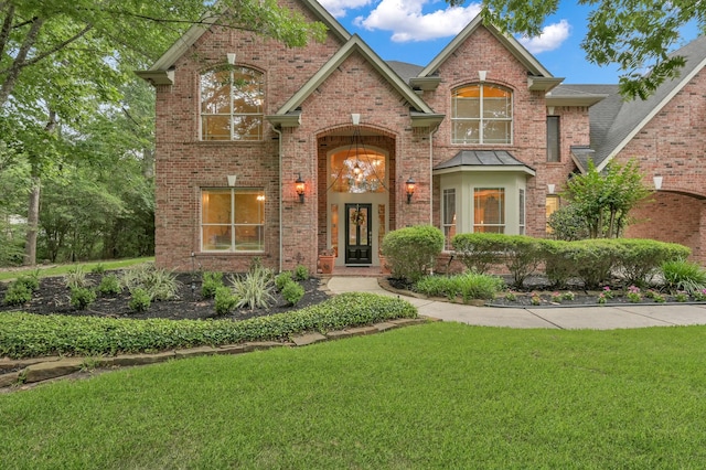 13262 Royal Rdg, Conroe, TX 77302 - traditional-style house featuring a front lawn and brick siding
