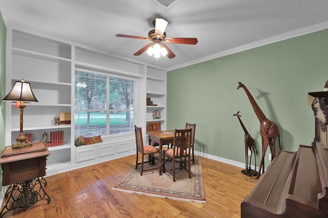 13262 Royal Rdg, Conroe, TX 77302 - dining room featuring built in features, crown molding, a ceiling fan, wood finished floors, and baseboards