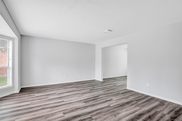 4523 Natural Bridge Dr, Kingwood, TX 77345 - spare room featuring wood finished floors and baseboards