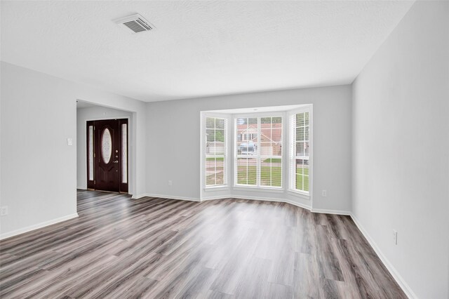 4523 Natural Bridge Dr, Kingwood, TX 77345 - unfurnished living room featuring wood finished floors and baseboards