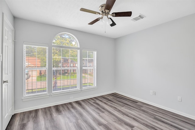 4523 Natural Bridge Dr, Kingwood, TX 77345 - spare room with wood finished floors, a ceiling fan, and baseboards