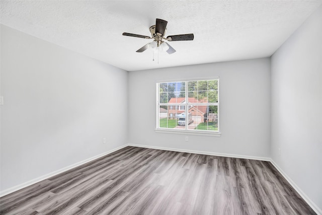 4523 Natural Bridge Dr, Kingwood, TX 77345 - spare room featuring wood finished floors, ceiling fan, a textured ceiling, and baseboards