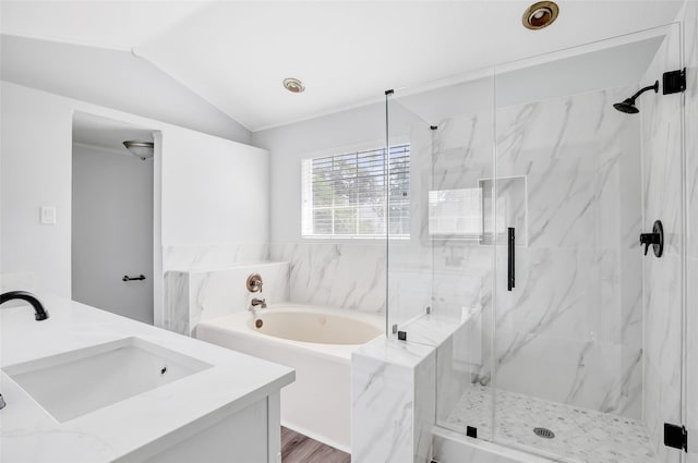 4523 Natural Bridge Dr, Kingwood, TX 77345 - full bathroom with a bath, vanity, a marble finish shower, lofted ceiling, and wood finished floors