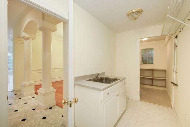 16 Treverstone Ct, Sugar Land, TX 77479 - clothes washing area with ornate columns, baseboards, and a sink