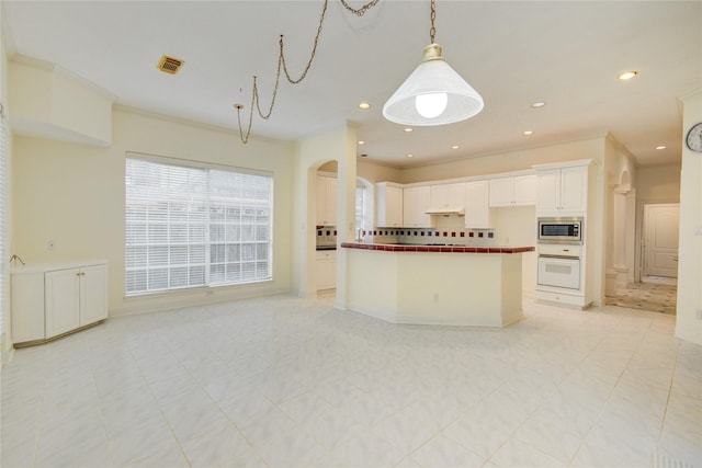 16 Treverstone Ct, Sugar Land, TX 77479 - kitchen featuring visible vents, crown molding, white oven, stainless steel microwave, and open floor plan