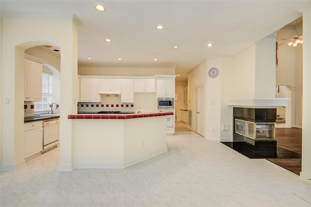 16 Treverstone Ct, Sugar Land, TX 77479 - kitchen with tile countertops, black stovetop, dishwasher, stainless steel microwave, and ornamental molding