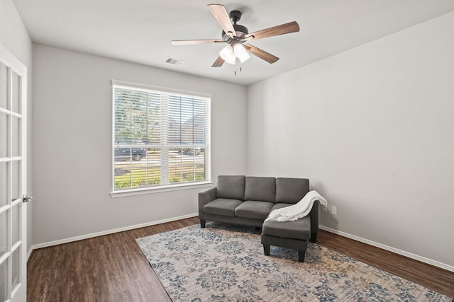sitting room with baseboards, visible vents, a healthy amount of sunlight, and wood finished floors
