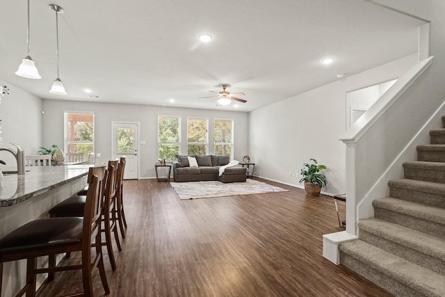 living room with ceiling fan, stairs, baseboards, recessed lighting, and dark wood-type flooring