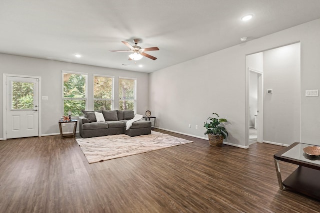 living area featuring plenty of natural light, a ceiling fan, and wood finished floors