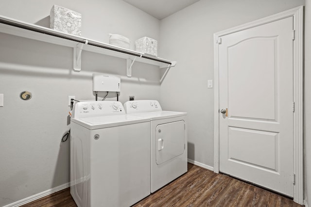 clothes washing area featuring laundry area, baseboards, independent washer and dryer, and dark wood-style floors