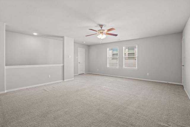 unfurnished room featuring a ceiling fan, baseboards, and carpet