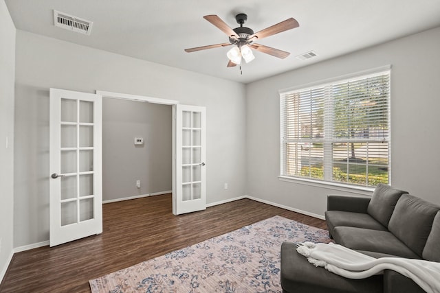 living area featuring french doors, wood finished floors, and visible vents
