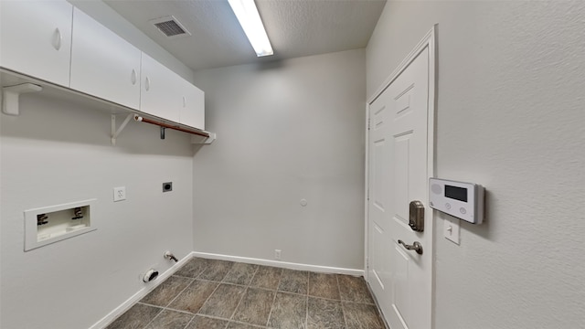 12107 Canyon Mills Dr, Houston, TX 77095 - washroom with cabinet space, hookup for a washing machine, gas dryer hookup, baseboards, and hookup for an electric dryer