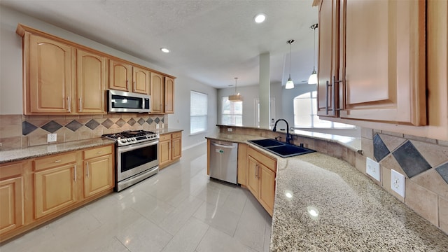 12107 Canyon Mills Dr, Houston, TX 77095 - kitchen with stainless steel appliances, a sink, decorative backsplash, light stone counters, and recessed lighting