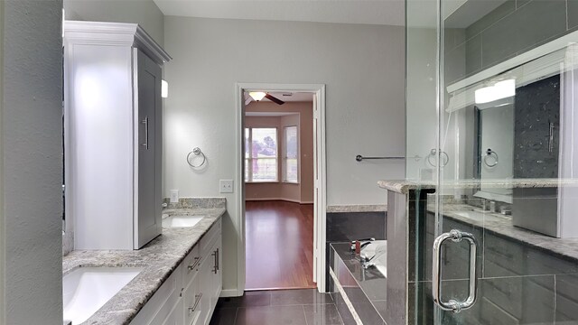 12107 Canyon Mills Dr, Houston, TX 77095 - full bathroom featuring tile patterned flooring, double vanity, a bath, ceiling fan, and a stall shower