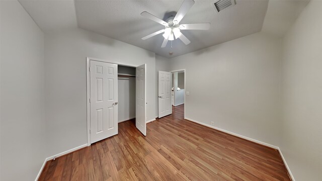 12107 Canyon Mills Dr, Houston, TX 77095 - unfurnished bedroom featuring baseboards, light wood finished floors, and a closet