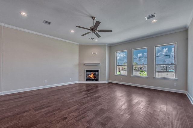 unfurnished living room featuring visible vents, ornamental molding, a glass covered fireplace, and ceiling fan