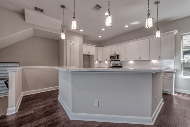 kitchen featuring visible vents, white cabinetry, backsplash, and stainless steel appliances