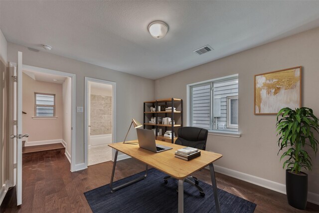 home office with baseboards, dark wood-style floors, and visible vents
