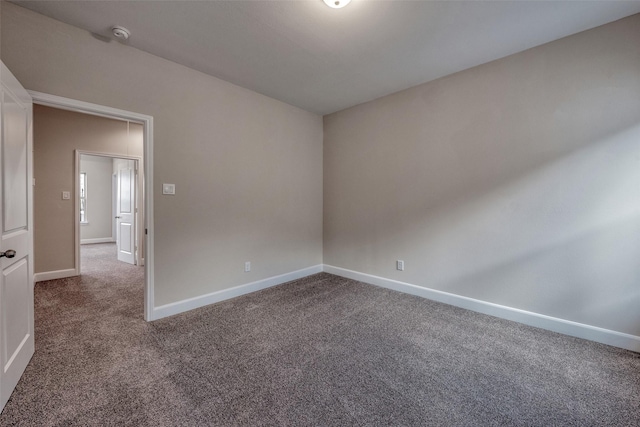 carpeted spare room with baseboards
