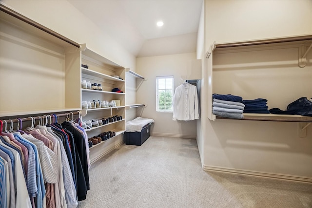 walk in closet with carpet and vaulted ceiling