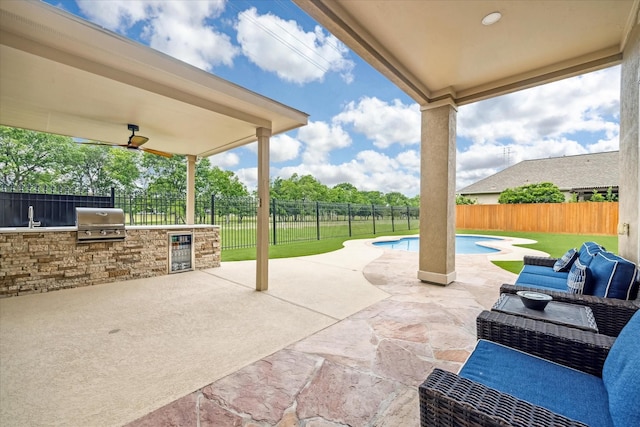 view of patio with a fenced backyard, grilling area, beverage cooler, and area for grilling