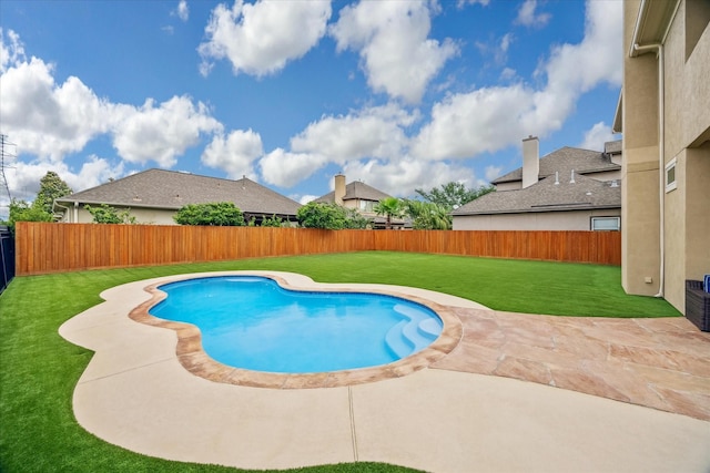 view of swimming pool with a fenced backyard, a fenced in pool, a lawn, and a patio area