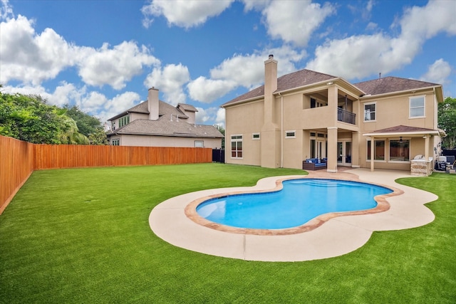 view of swimming pool featuring a yard, a patio, and a fenced backyard