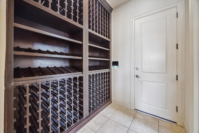 wine area featuring tile patterned floors and baseboards