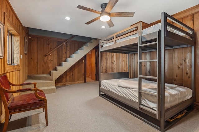 carpeted bedroom featuring wooden walls, recessed lighting, and ceiling fan
