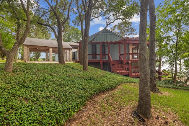 rear view of house featuring a deck