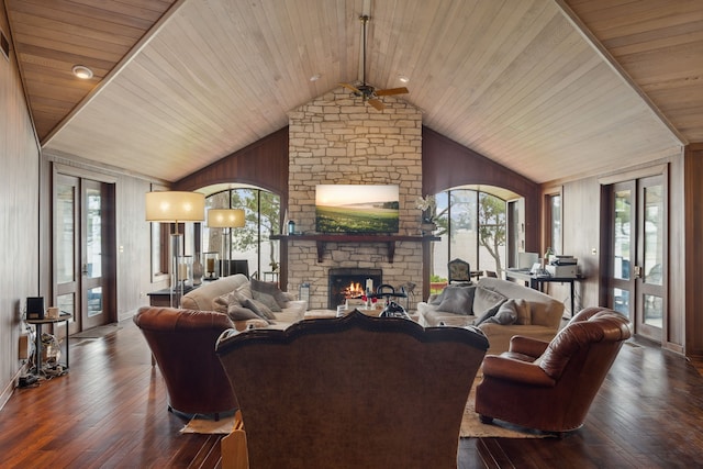 living room with plenty of natural light, a ceiling fan, vaulted ceiling, and a fireplace
