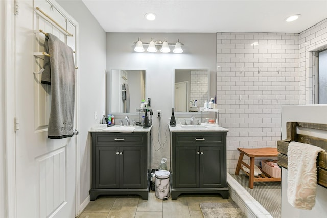 full bathroom featuring a sink, tile patterned floors, and two vanities