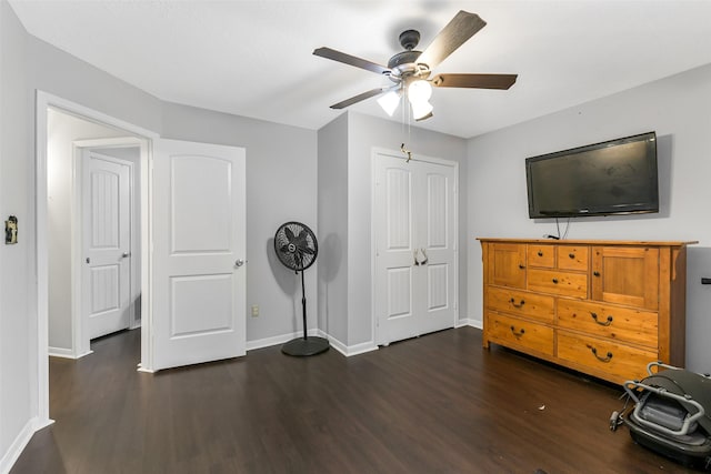 bedroom featuring baseboards, a closet, and dark wood finished floors