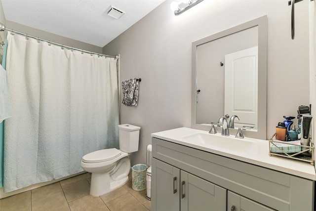 bathroom featuring visible vents, vanity, toilet, a shower with shower curtain, and tile patterned floors