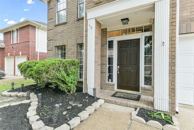 entrance to property featuring brick siding