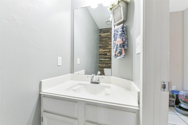 bathroom featuring vanity, tile patterned floors, and toilet