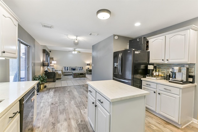 kitchen with dishwasher, black refrigerator with ice dispenser, a ceiling fan, open floor plan, and visible vents