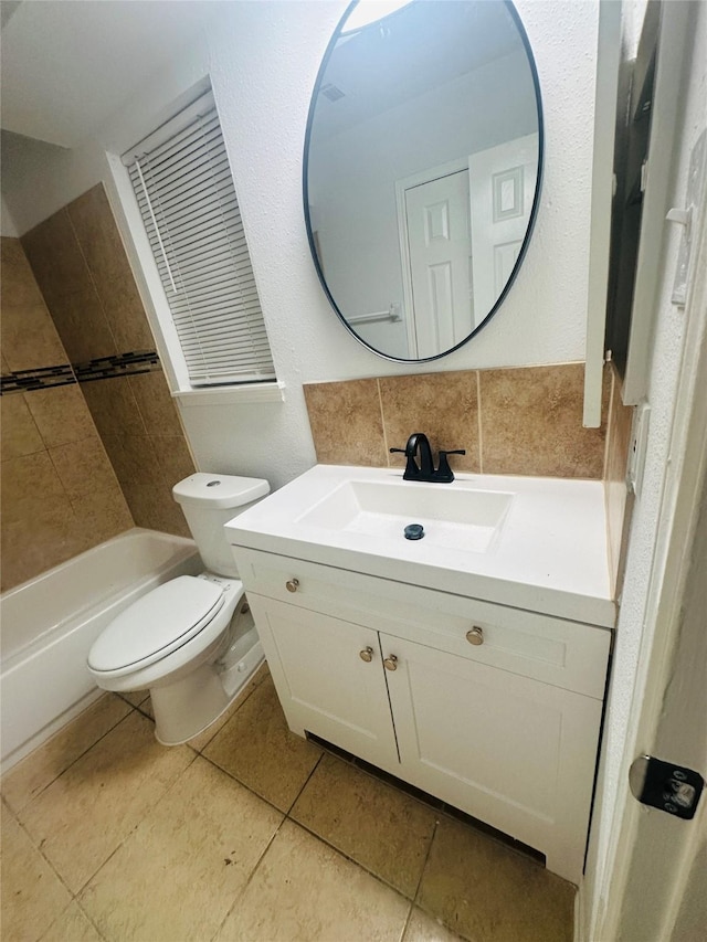 full bathroom featuring vanity, washtub / shower combination, tile patterned floors, and toilet
